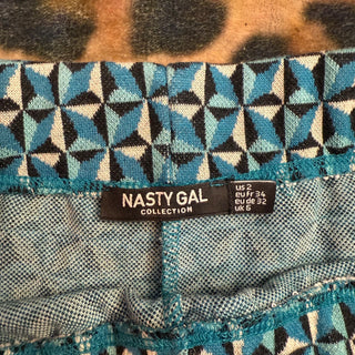 Nasty Gal label on a patterned fabric background